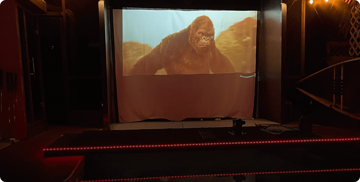 Outdoor movie screen showing giant gorilla film.