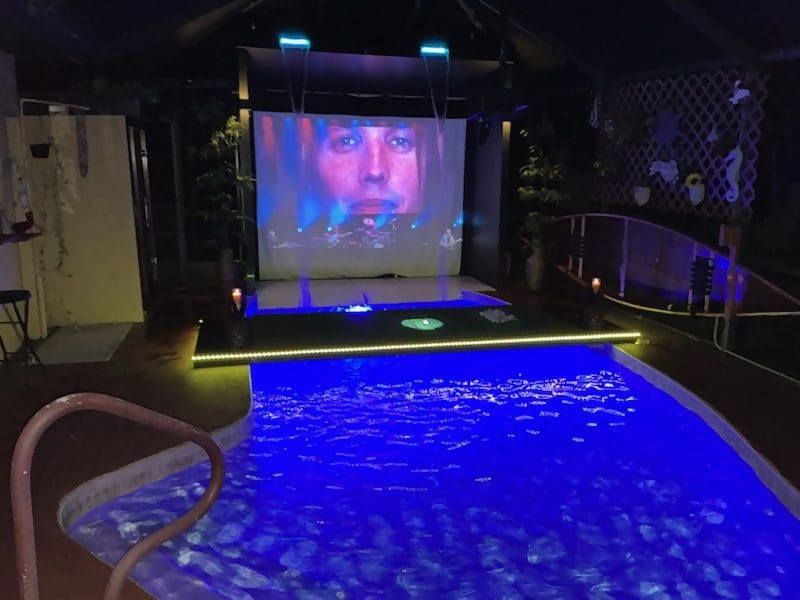 Home theater with pool and large screen.